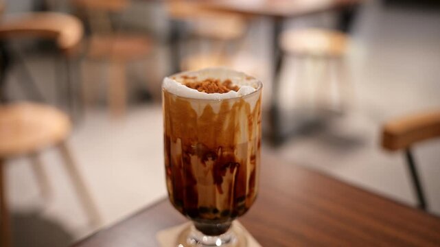 Taiwanese bubble milk tea with black tapioca pearls in a Hong Kong cafe. Visual representation of the popular Asian beverage trend and global consumer food culture.