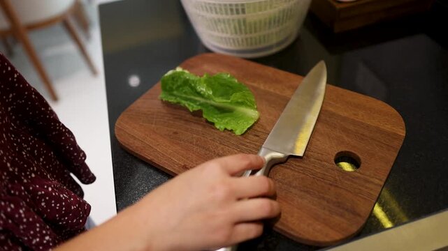 Caucasian Woman Chef Preparing Fresh Lettuce on Wooden Cutting Board