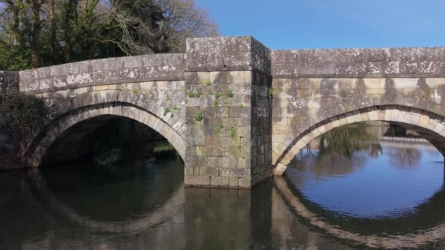Ancient Stone Bridge Over The Xallas River With Brandomil Roman Bridge In Zas, Galicia, Spain. Aerial Sideways Shot