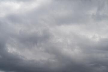 Fototapeta premium Gloomy cloudy scene. Clouds cover gray landscape completely. Overcast sky conceals muted surroundings entirely. Thick cloud cover obscures subdued environment entirely from view
