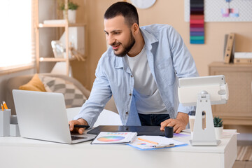 Male interior designer working in office