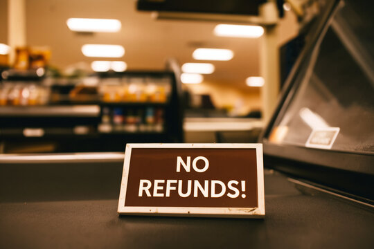 A sign on a store counter clearly displays the store's refund policy to customers.