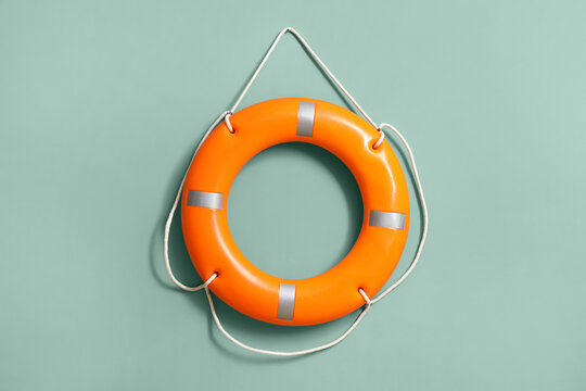Lifebuoy hanging on green wall