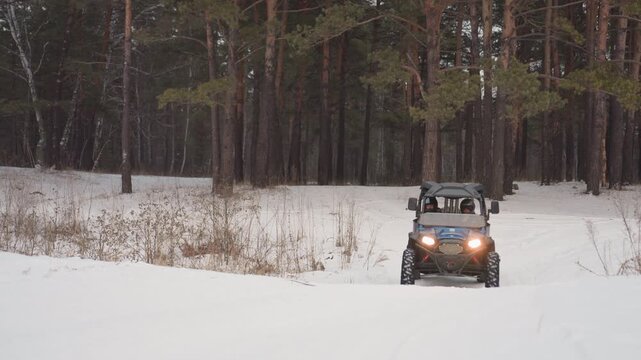 Closeup atv wheels carving snowy trail, intense technical shot showing suspension travel, tire tread grip, helmeted driver focused, headlights blazing, high adrenaline performance