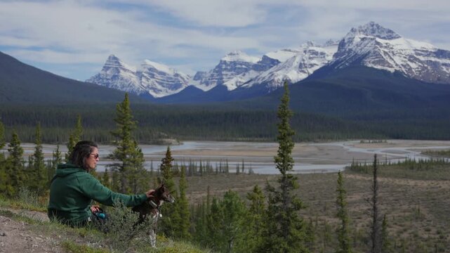 Woman and dog enjoying Jasper National Park mountain view