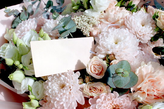 There is a card for an inscription in the bouquet of flowers.