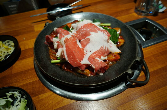 stir fried beef sliced with korean chili paste on hot pan - korean food style