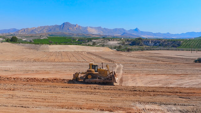 D10 bulldozer crawler tractor in the process of scarifying earth platforms