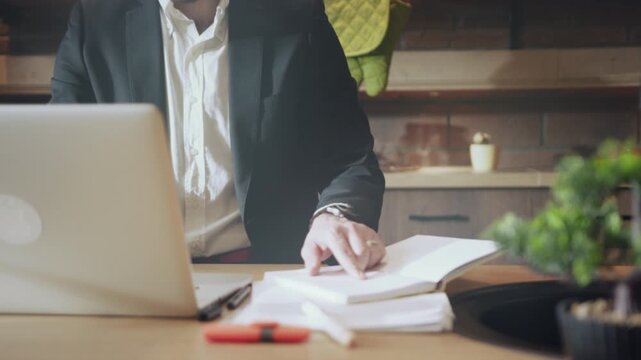 Man typing at home desk, Man concentrating on tasks in comfortable home office environment with natural lighting