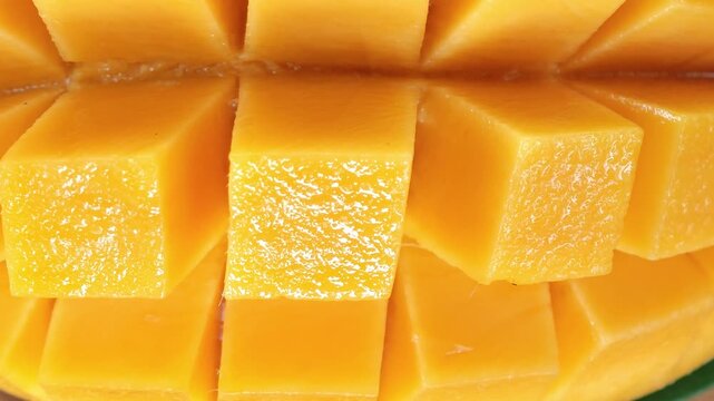 Fresh Mango sliced ​​and leaf on a wooden plate.