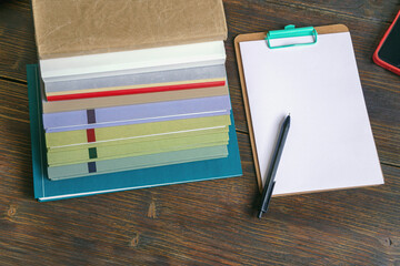 Workspace with stack of books and clipboard. Copy space © Olga Iljinich