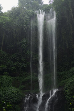 Tropical waterfall cascading through lush green jungle, Sekumpul, Bali
