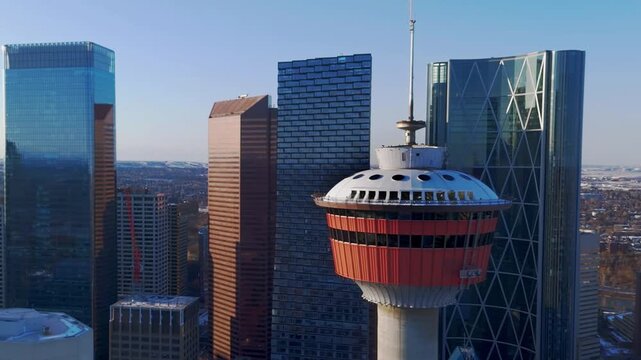 Cinematic drone orbit of the Calgary Tower highlighting modern skyscrapers in the urban core in Calgary, Alberta, Canada.