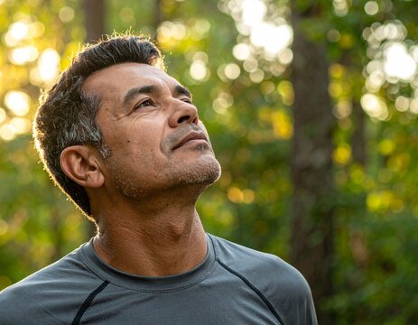 Half-Body Nature Portrait of Man Standing in Forest with Blurred Trees Background