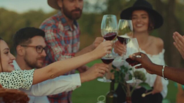 Friends gather outside to celebrate with lively drinks, Group of friends relishing wine at vibrant outdoor occasion