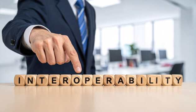 Interoperability - Geschäftsmann zeigt auf das Wort "Interoperability"