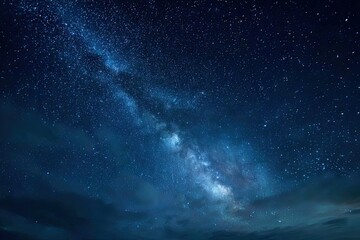 Fototapeta premium A breathtaking view of the Milky Way galaxy stretches across a dark, clear night sky, showcasing countless stars and a vibrant celestial panorama.