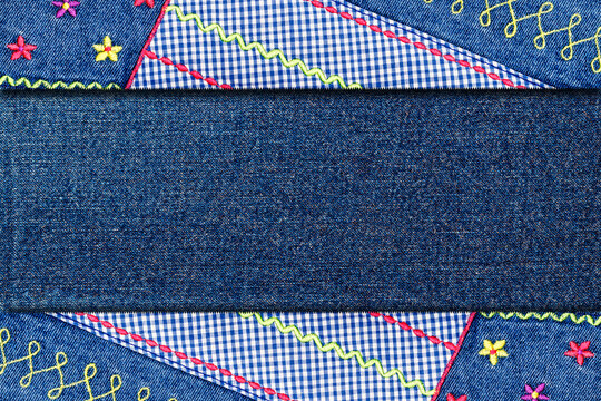 Handmade patchwork design with denim and colorful stitches on fabric