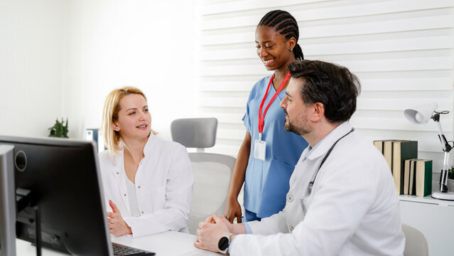 Healthcare team discusses patient care in a modern clinic setting during a workday