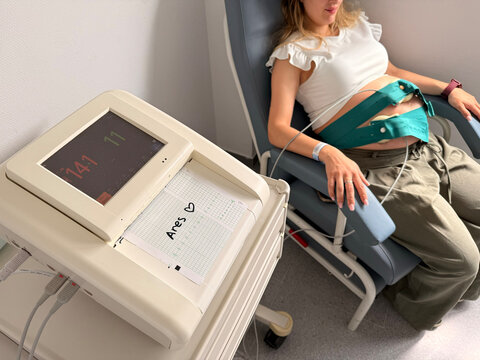 Pregnant woman undergoing fetal heart rate monitoring scan