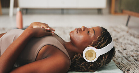 Headphones, woman and relax on floor for yoga, wellness or self affirmation audio for mental...