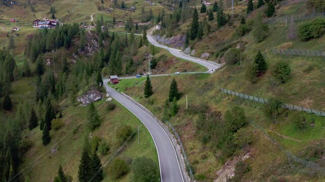 Scenic turns of the Giau pass in the Dolomite Alps on an autumn day. Drone video
