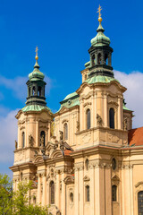 Fototapeta premium St Nicholas Church Prague in spring with blue sky