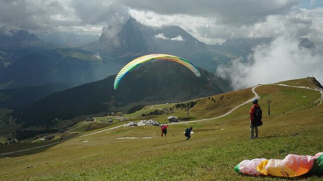 Paragliding activities at Seceda Mount in the Dolomite Alps, Italy