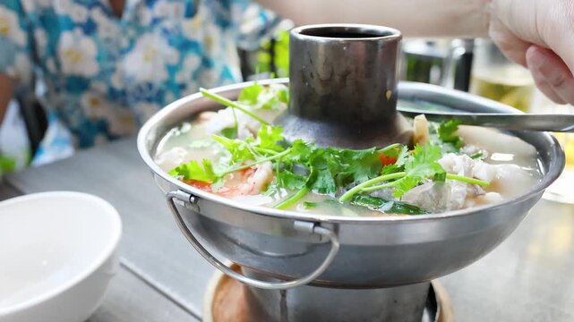 Traditional Thai Tom Yum Shrimp Hot Pot Soup Served Outdoors