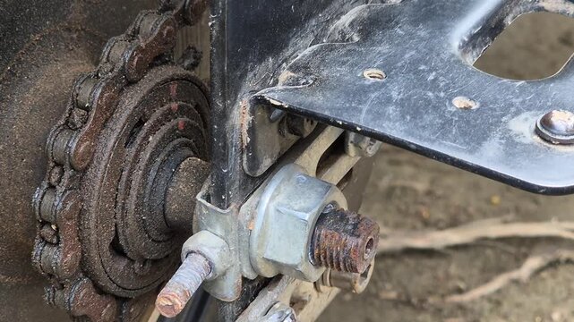 Close Up of Rusty Bicycle Chain and Rear Axle Nut Rotating