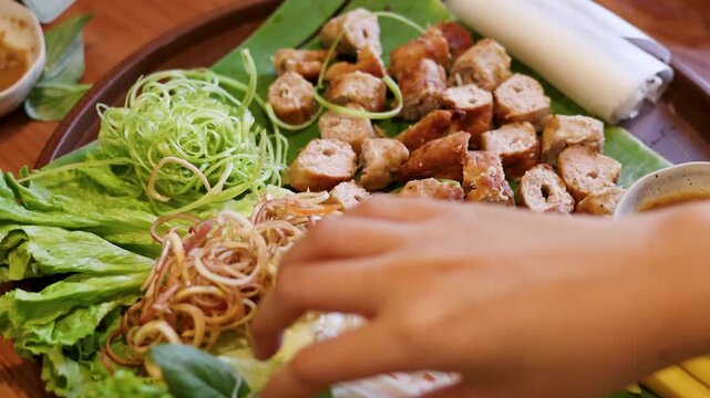 Vietnamese Nem Nuong Grilled Pork Sausage Platter with Fresh Herbs