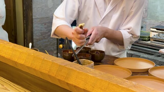 Japanese Omakase Chef Shaving Bottarga Fish Roe into Wooden Bowls