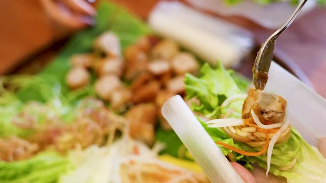 Vietnamese Nem Nuong Spring Roll Preparation with Dipping Sauce