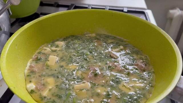 Video. Close-up. Cooking a frittata with vegetables for breakfast.