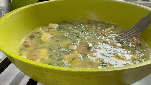 Video. Close-up. Cooking a frittata with vegetables for breakfast.