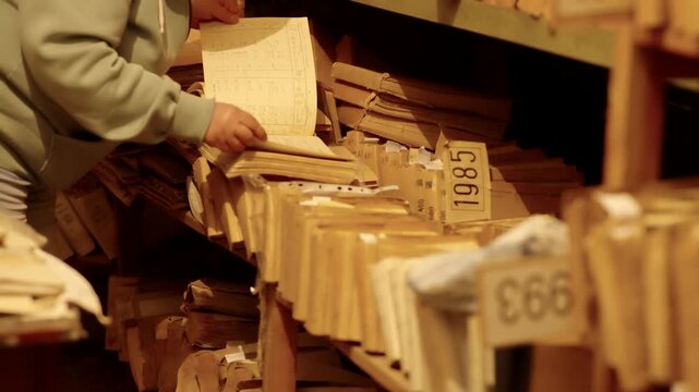 Searching For Information In Old Paper Documents. Vintage Records On Archive Shelves