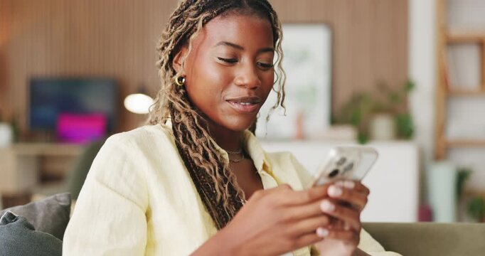 Laugh, typing and black woman in house with phone, online communication and comic post on social media. Happy, digital and person on sofa with tech, funny text message or meme reaction on chat app.