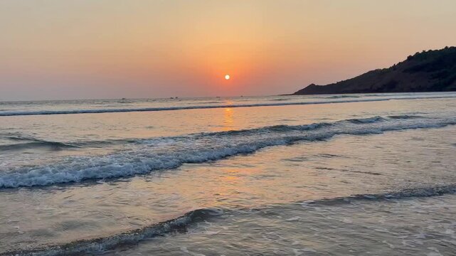Mesmerizing 4K sunset view of Aare Ware Beach, Ratnagiri. Warm orange skies, sparkling waters, and peaceful shoreline create a perfect seaside moment.