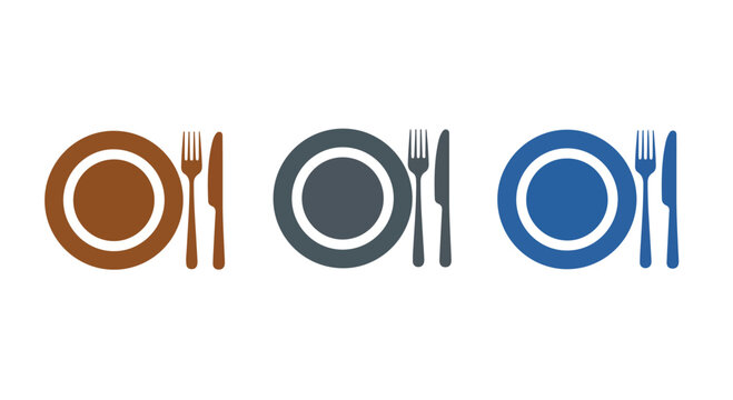 Set of three colorful ceramic plates with matching cutlery arranged on a flat surface for dining or table setting