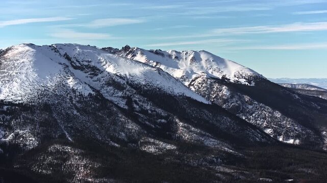 70mm-style aerial drone shot of snowy peaks surrounding Dillon and Frisco near Breckenridge in Colorado's Rocky Mountains.