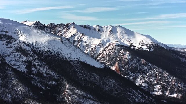 70mm-style aerial drone shot of snowy peaks surrounding Dillon and Frisco near Breckenridge in Colorado's Rocky Mountains.
