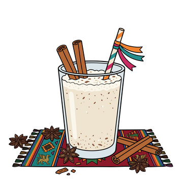 Traditional mexican horchata drink in glass with cinnamon sticks and spices on colorful textile background beverage concept