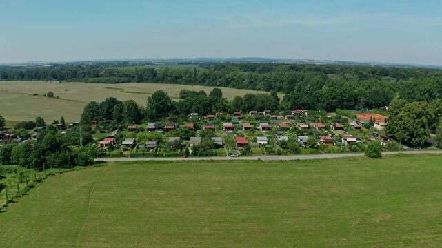 Aerial side drone shot of small gardens in ostrava suburb