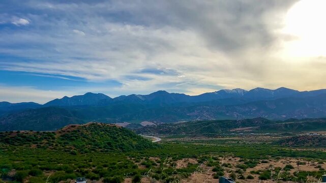 Beautiful golden hour sunset over a mountain scape freeway in California during the month of early April 2026.