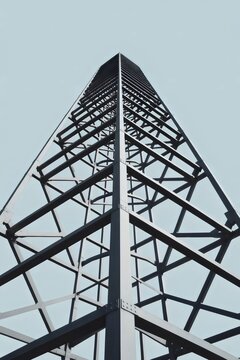 Minimalist steel tower on blue &ndash; Suitable for tech blogs, engineering firms, or signal strength data visualization.