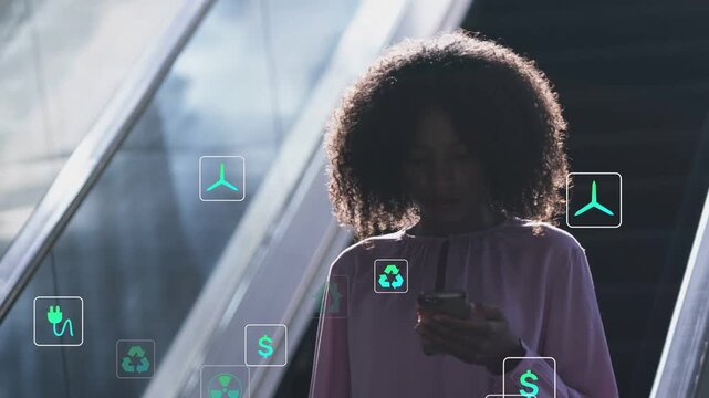 Woman using phone initiating green tech icons rising grouping over torso showing eco data