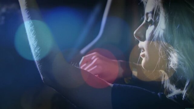 Woman singer raising arm, pointing mic, singing while bokeh overlaying stage, reacting to motion