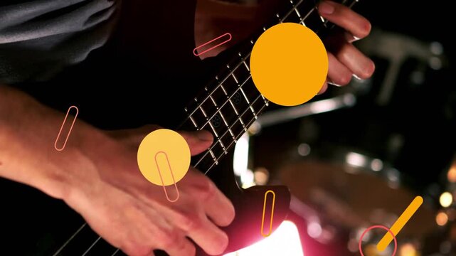 Bassist plucking strings while music sending circles and bars floating hiding then showing strings