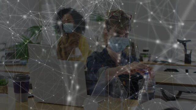 Front coworker reaching for pump and sanitizing hands for hygiene in office, overlay mapping hands