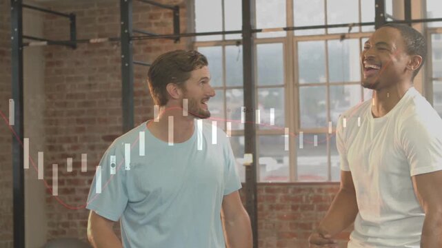 Chatting two men trading laughs and gestures in loft, with moving equalizer and blue or white T-shir